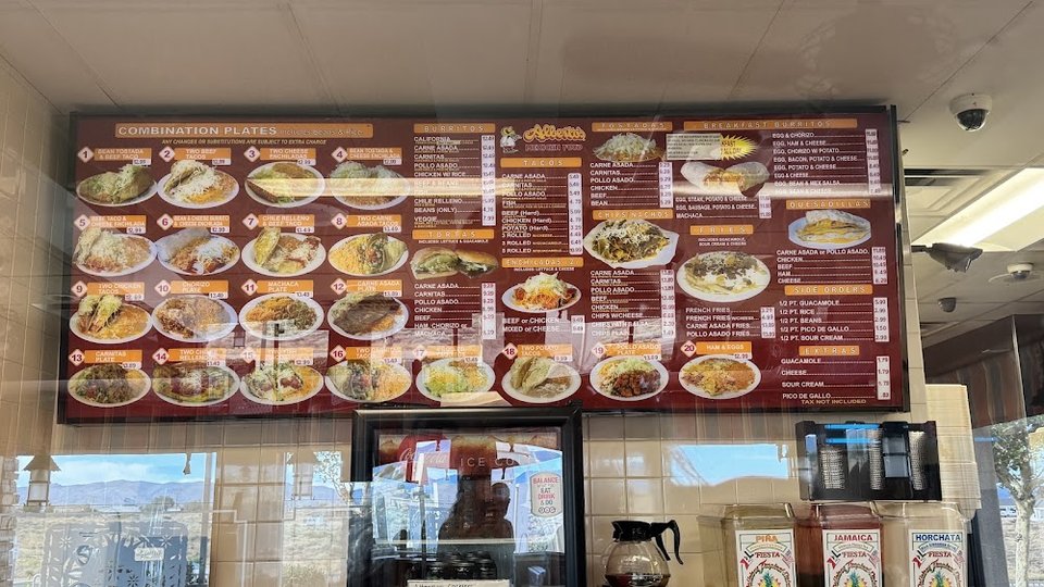 Menu board with burritos, tacos, and enchiladas.