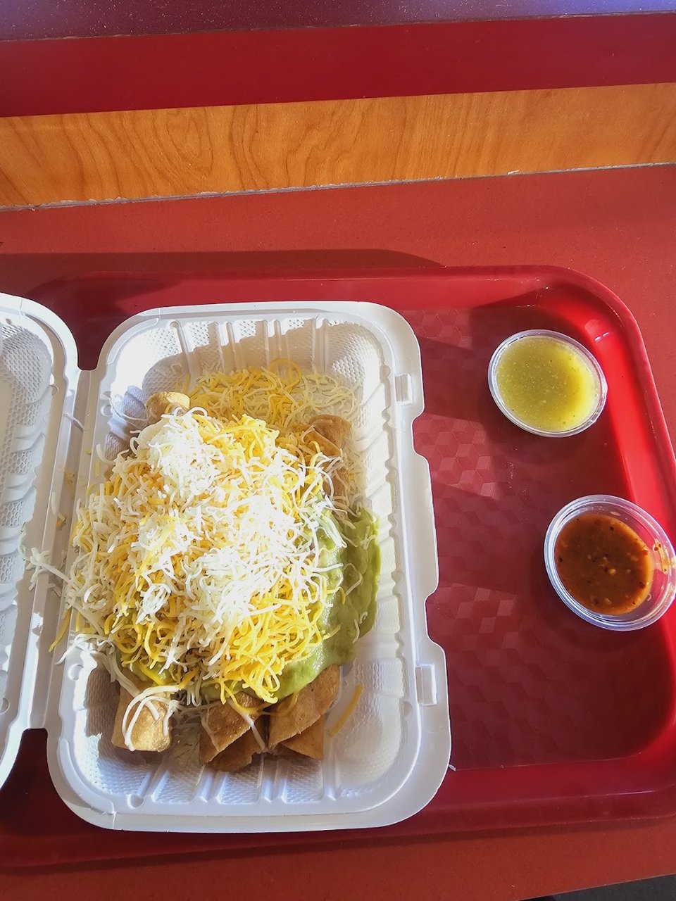 Menu board with burritos, tacos, and enchiladas.