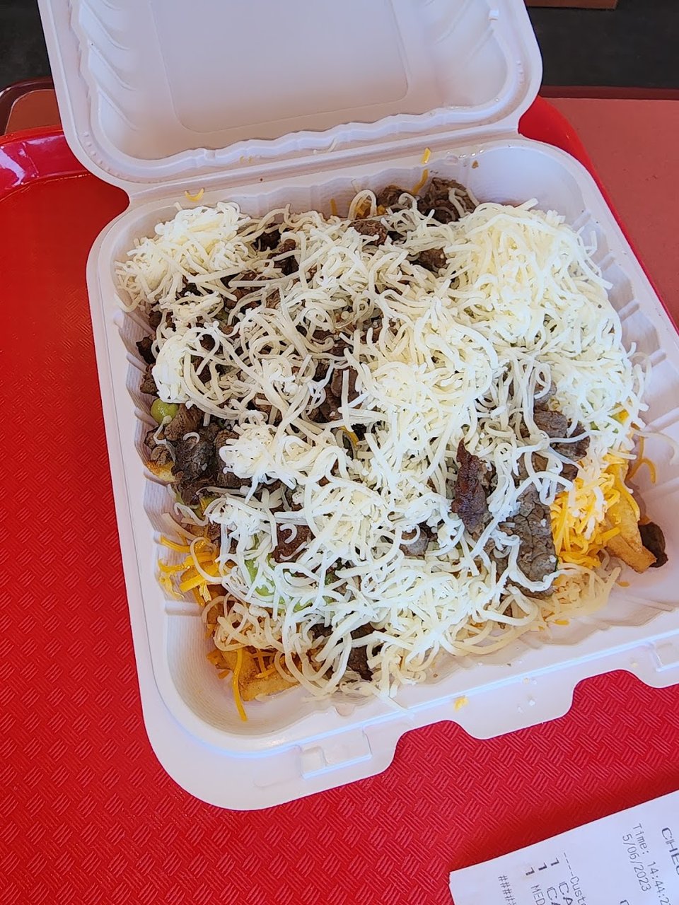 Menu board with burritos, tacos, and enchiladas.